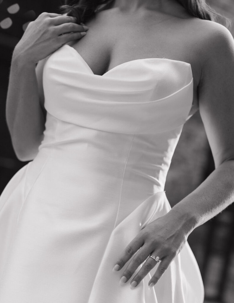 Close-up of the bride’s elegant gown fabric and ruching details before the ceremony.