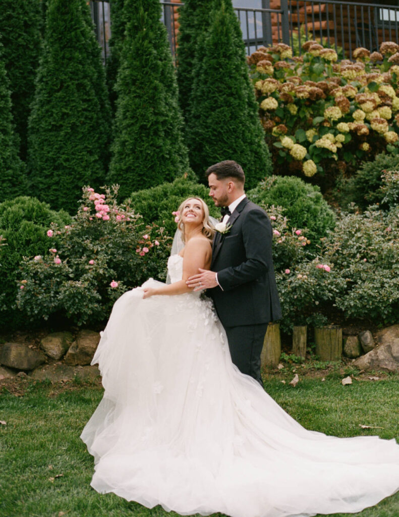 Newlywed photo during an Ohio wedding celebration with greenery in the background.