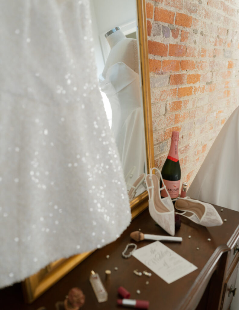 Flat-lay of bridal accessories, including shoes and perfume, photographed at The Ellis.