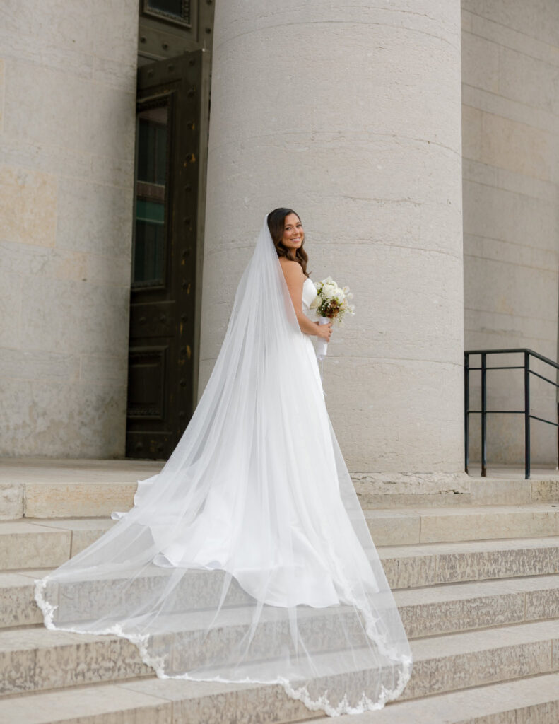 Bride walking through the grand entrance of The Ellis during her black-tie Columbus, Ohio wedding.