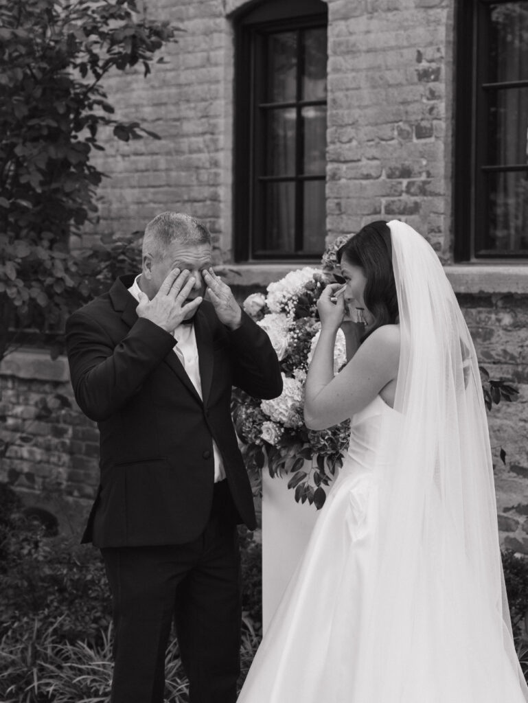 Father of the bride crying seeing his daughter for the first time at her wedding.