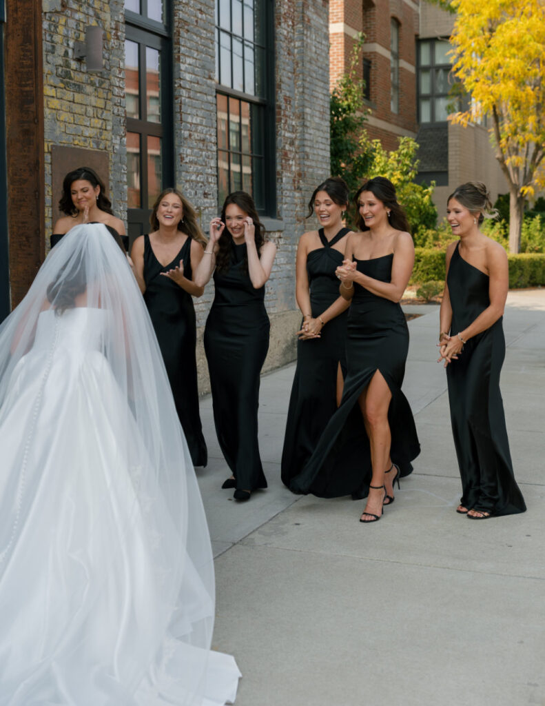 The wedding party seeing the bride together downtown by The Ellis.