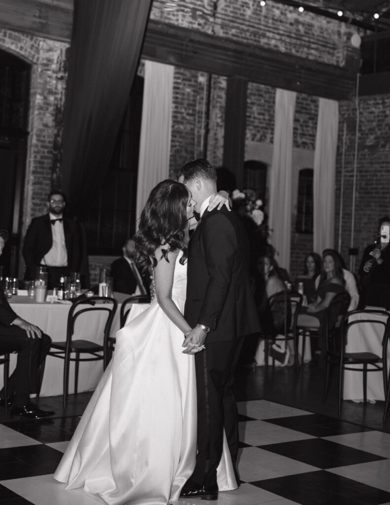 Black-and-white film portrait of the bride and groom's first dance at The Ellis.