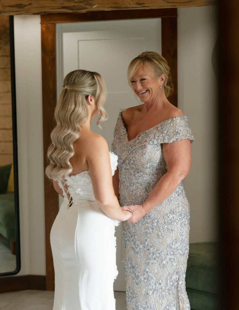 Tender moment between the bride and her mother while getting ready.