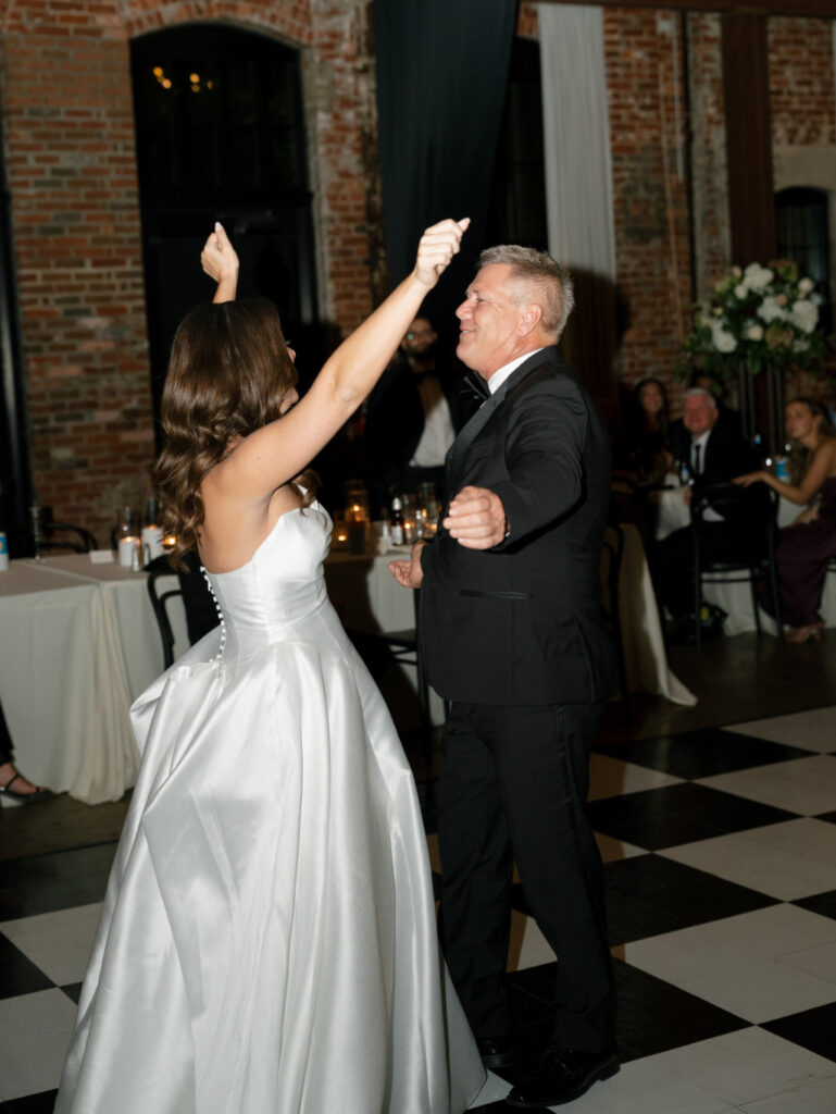 Father of the bride and bride dancing at the wedding reception.