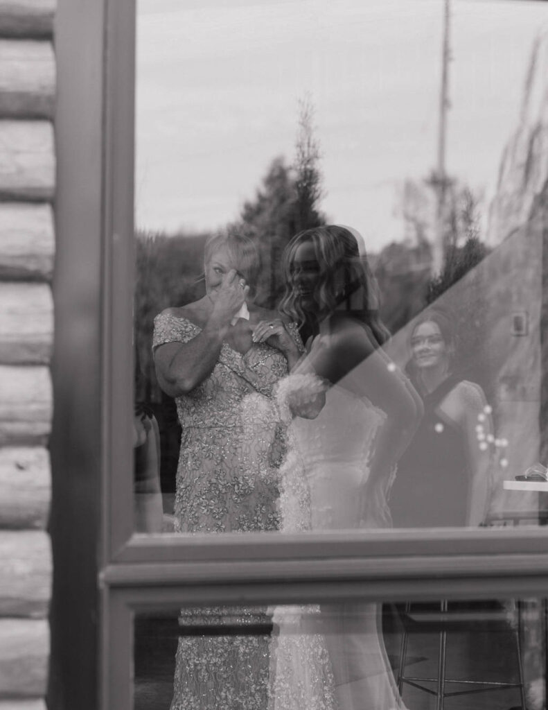 Film-style black-and-white moment of the groom waiting at the altar.