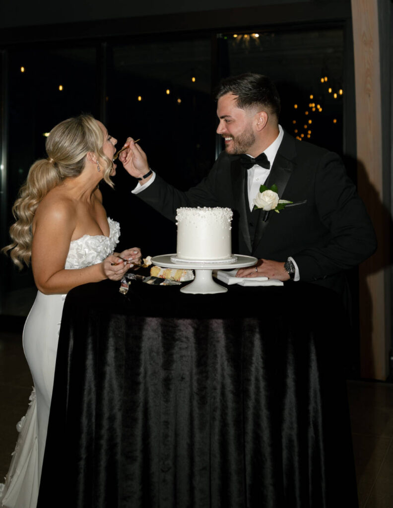 Bride and groom cutting their wedding cake during the reception at The Everhart Gathering Place