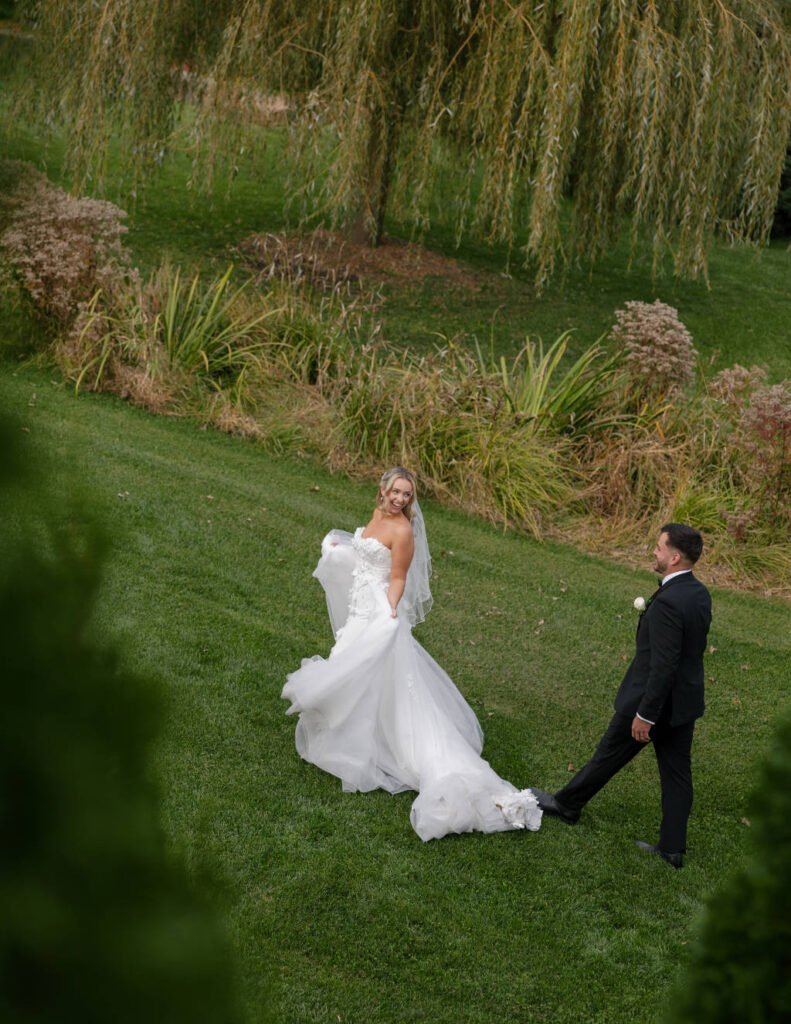 Hidden shot of newly married bride and groom outdoors at an Ohio wedding.