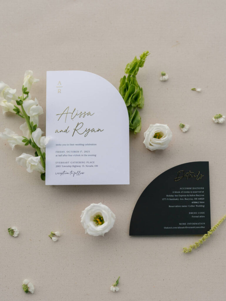 Close-up of wedding invitations and accessories styled beautifully.