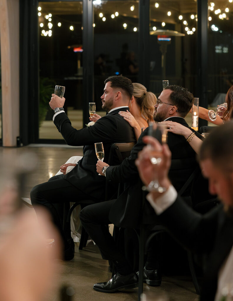 Bride and groom raising glasses during their wedding toast.